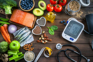 Assortment of healthy foods with medical tools promoting heart health and wellness
