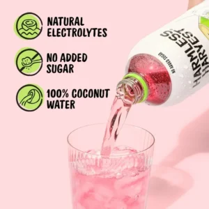 Bottle of Harmless Harvest coconut water being poured into a glass with product benefits highlighted