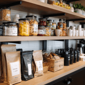 Office pantry shelves stocked with coffee, snacks, and healthy food options in a modern break room